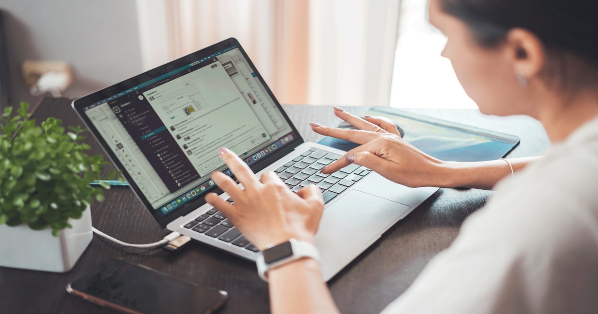 Person packing online orders at home, deciding whether their side hustle is a business.
